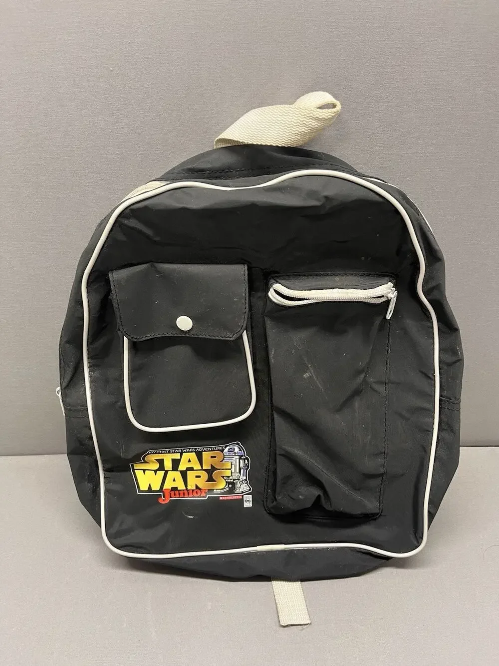 vintage 1999 Star Wars Junior black book bag with a white-trimmed R2-D2 logo.